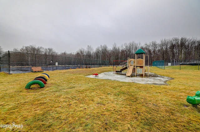community play area featuring fence and a yard
