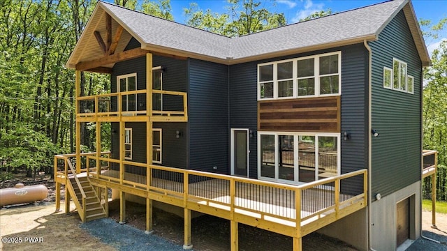 128 Copper Mountain Dr, Tafton, PA 18464 - back of property featuring a balcony, a shingled roof, a deck, and an attached garage