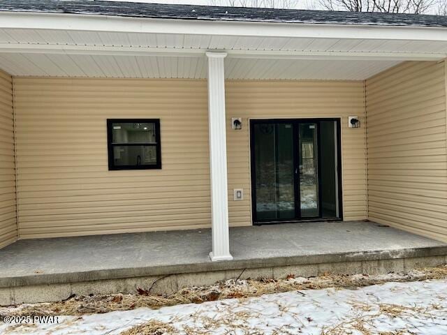 view of snow covered property entrance