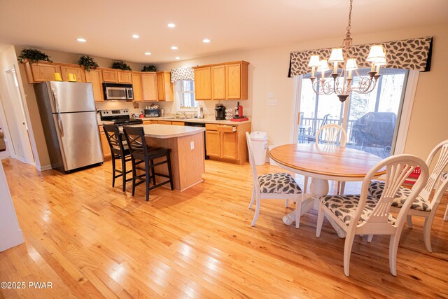 92 Thornwood Ter, Lake Ariel, PA 18436 - kitchen featuring light countertops, a notable chandelier, stainless steel appliances, light wood-type flooring, and light brown cabinetry