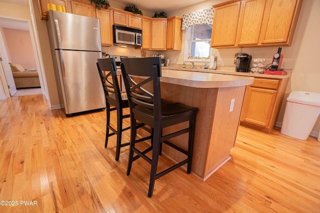 92 Thornwood Ter, Lake Ariel, PA 18436 - kitchen with a kitchen island, light wood-type flooring, light countertops, and stainless steel appliances