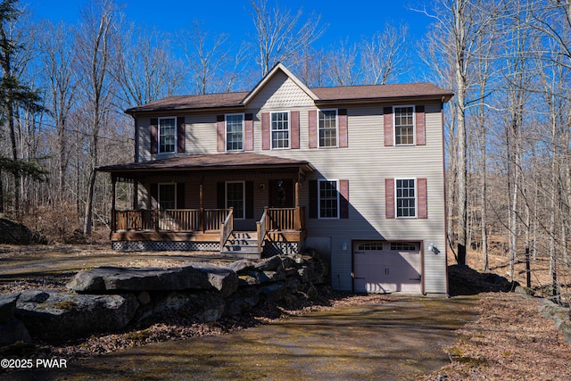 92 Thornwood Ter, Lake Ariel, PA 18436 - view of front facade featuring dirt driveway, a garage, and a porch