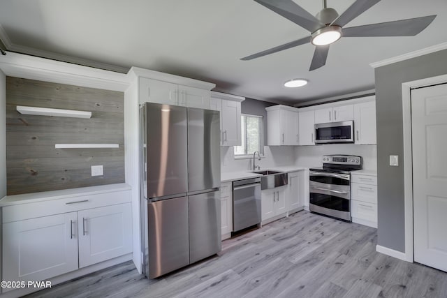 146 Country Club Dr, Thornhurst, PA 18424 - kitchen featuring appliances with stainless steel finishes, crown molding, a ceiling fan, white cabinets, and light countertops