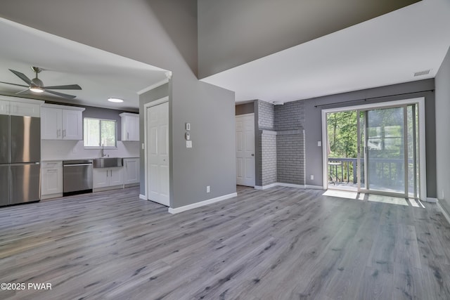 146 Country Club Dr, Thornhurst, PA 18424 - unfurnished living room featuring a ceiling fan, plenty of natural light, and light wood-style flooring