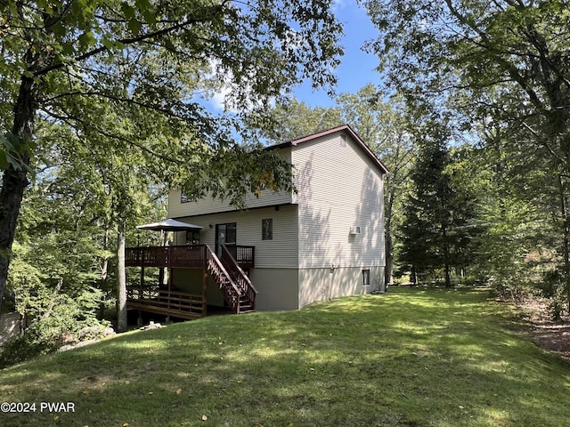 back of house with a lawn and a deck