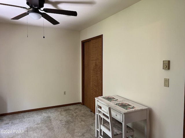 carpeted spare room with ceiling fan