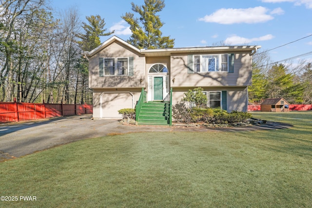 631 Silver Lake Rd, Dingmans Ferry, PA 18328 - bi-level home featuring a front lawn, fence, a garage, and aphalt driveway