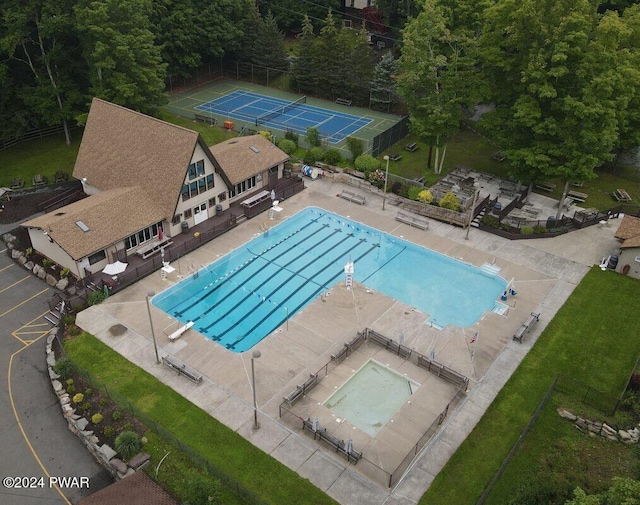 view of swimming pool with tennis court