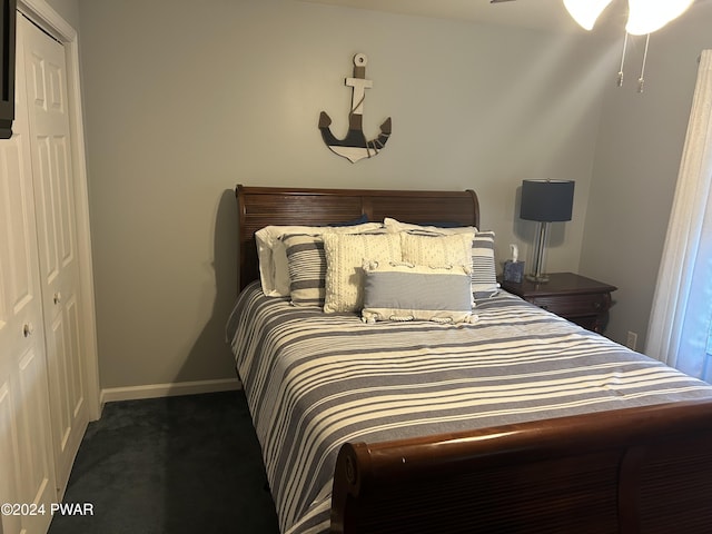 bedroom with dark carpet and a closet