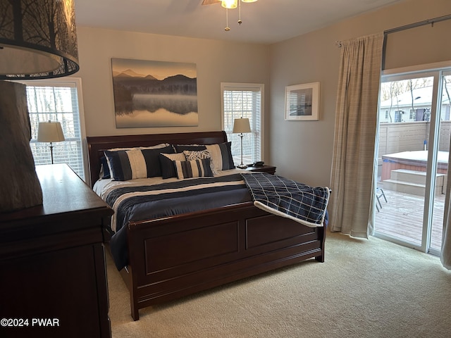 bedroom featuring access to outside, light colored carpet, and ceiling fan