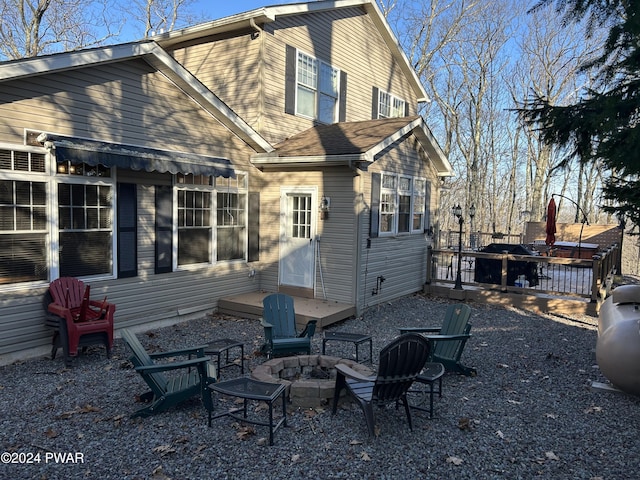 back of house with an outdoor fire pit