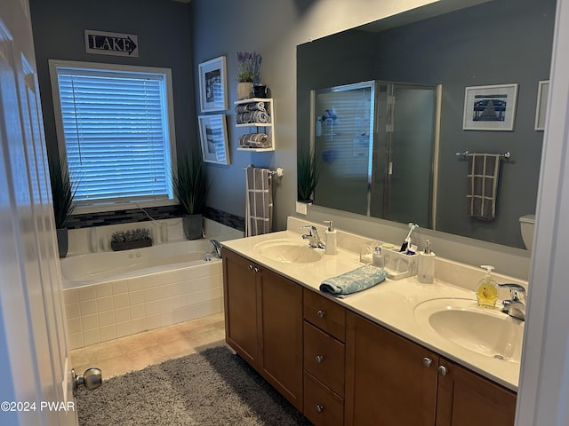 bathroom featuring shower with separate bathtub, vanity, and tile patterned floors