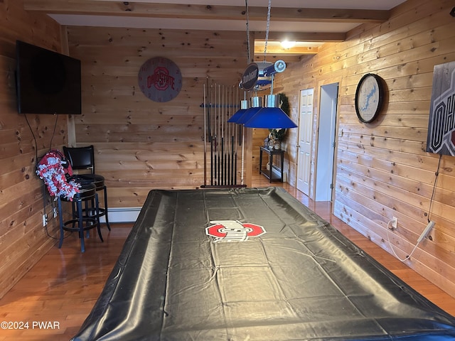 recreation room with beam ceiling, wood walls, and hardwood / wood-style flooring