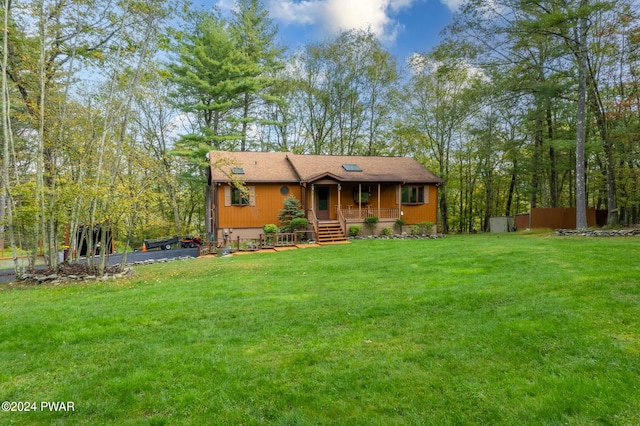 view of front of house featuring covered porch and a front lawn