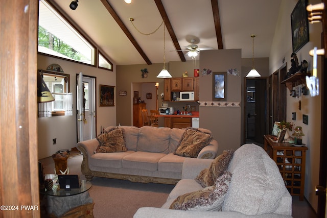 living room with vaulted ceiling with beams, ceiling fan, and sink