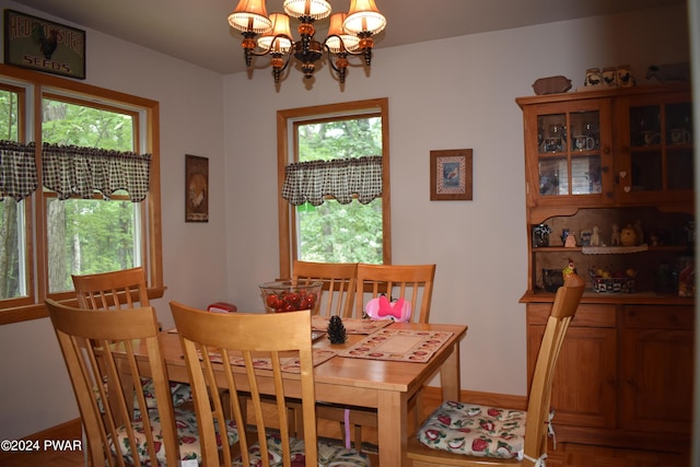 dining space featuring an inviting chandelier and a healthy amount of sunlight