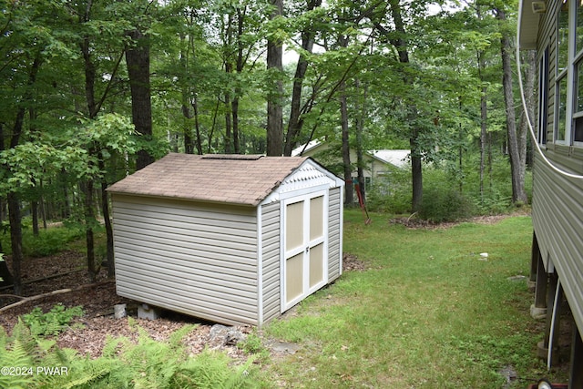 view of outbuilding featuring a lawn