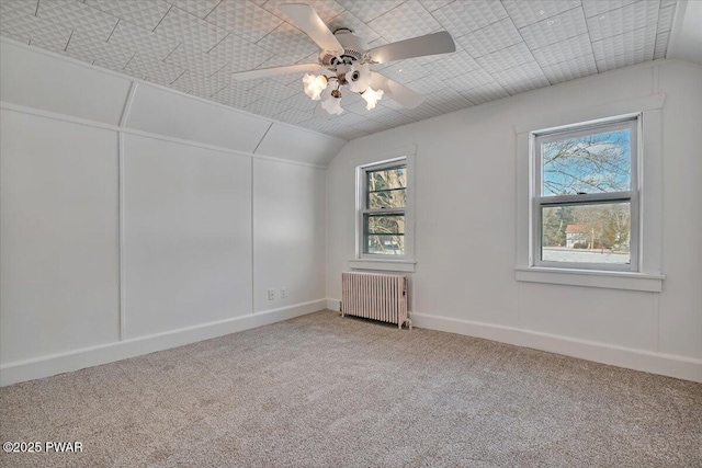 bonus room with carpet floors, lofted ceiling, radiator, and a wealth of natural light