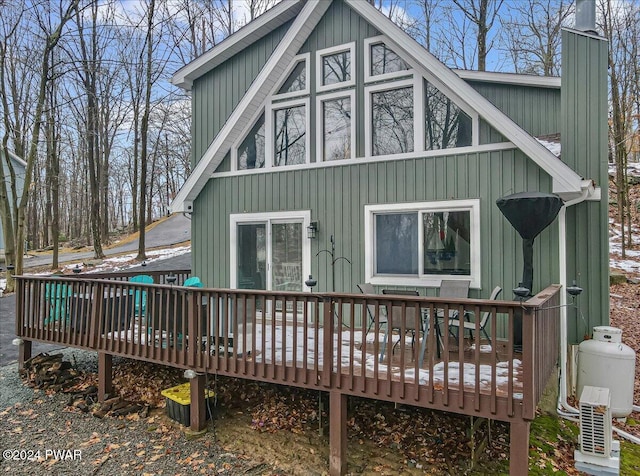 rear view of property featuring a deck