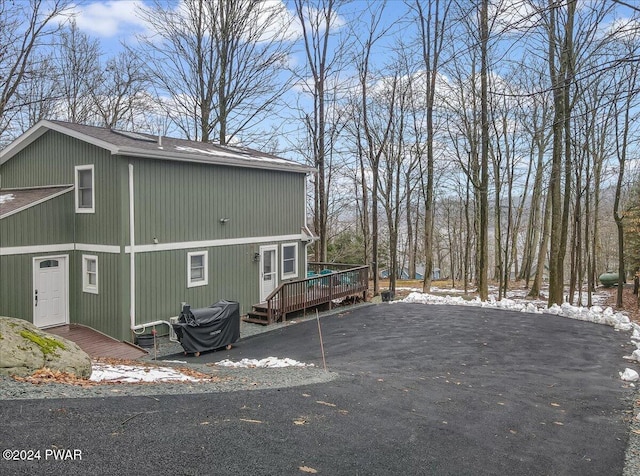 snow covered property featuring a wooden deck