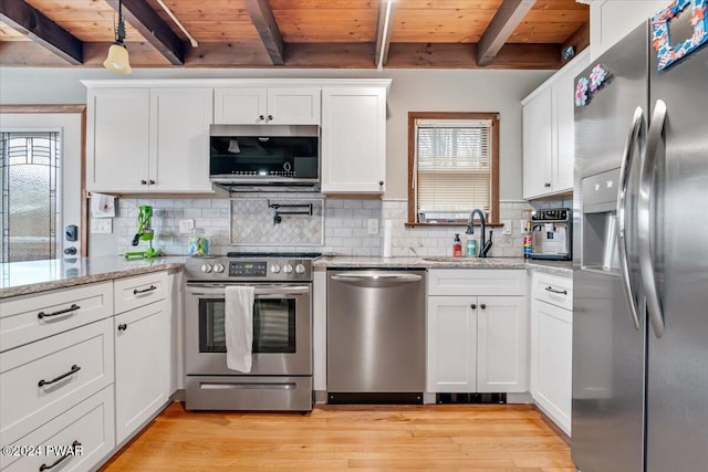 kitchen featuring beamed ceiling, wood ceiling, and appliances with stainless steel finishes