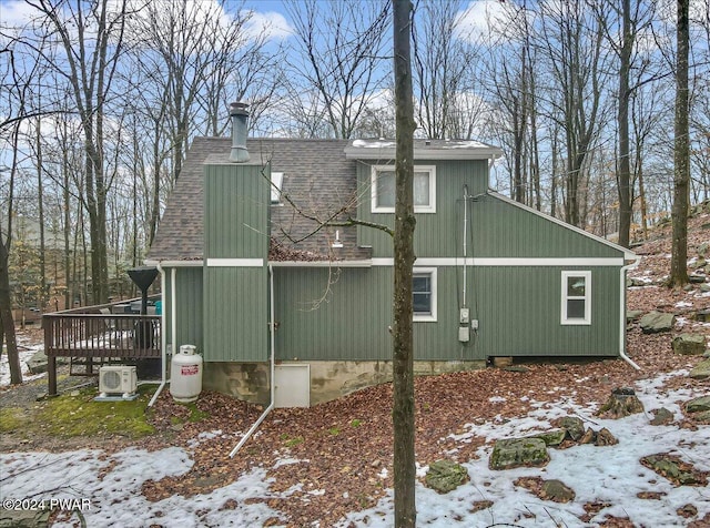 view of snowy exterior with a deck