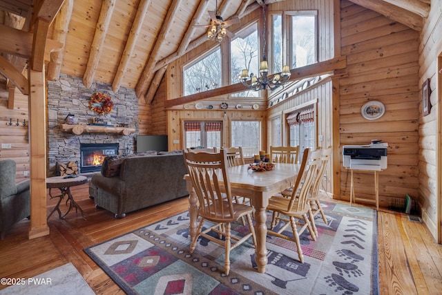 dining room featuring wood-type flooring, high vaulted ceiling, wood ceiling, and beam ceiling