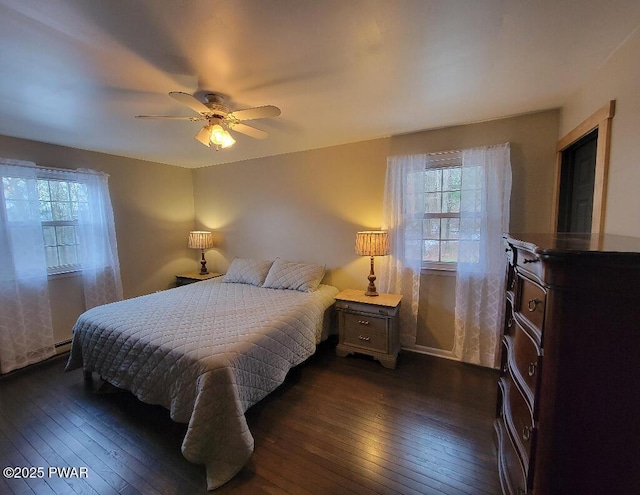 bedroom with dark wood finished floors and a ceiling fan