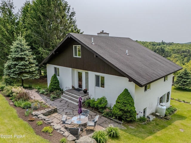 113 Jacobs Ladder Rd, Starrucca, PA 18462 - rear view of property with a lawn, a patio area, a chimney, stucco siding, and roof with shingles