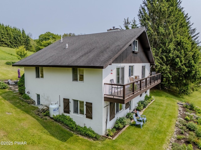 113 Jacobs Ladder Rd, Starrucca, PA 18462 - rear view of property featuring a shingled roof, a yard, a deck, stucco siding, and a chimney