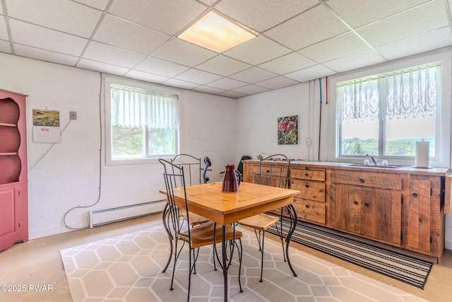 113 Jacobs Ladder Rd, Starrucca, PA 18462 - dining space with baseboard heating, concrete block wall, a drop ceiling, and concrete floors