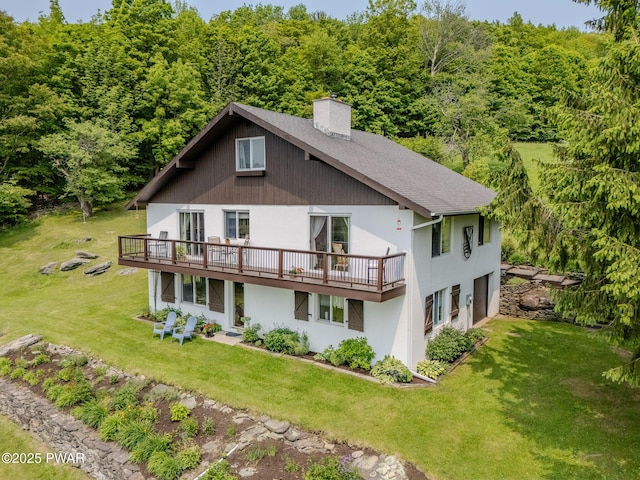113 Jacobs Ladder Rd, Starrucca, PA 18462 - rear view of house featuring a deck, a chimney, stucco siding, a lawn, and a forest view