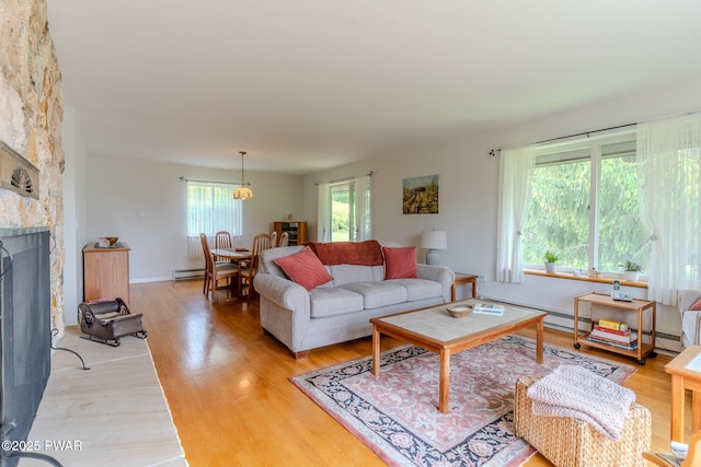 113 Jacobs Ladder Rd, Starrucca, PA 18462 - living area featuring light wood finished floors, a fireplace, and a baseboard heating unit