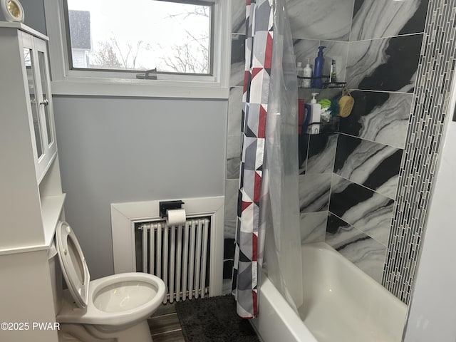 full bath featuring radiator, shower / bath combo, toilet, and wood finished floors