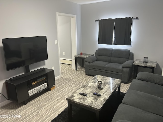 living room with a baseboard radiator, baseboards, and wood finished floors