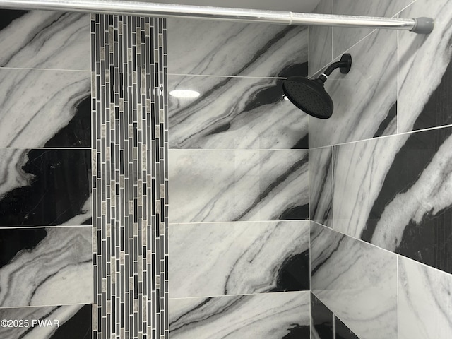 interior details with a tile shower