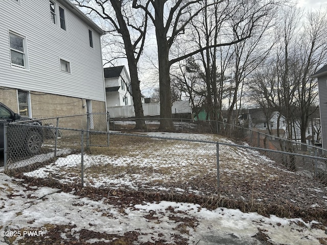 yard layered in snow with fence