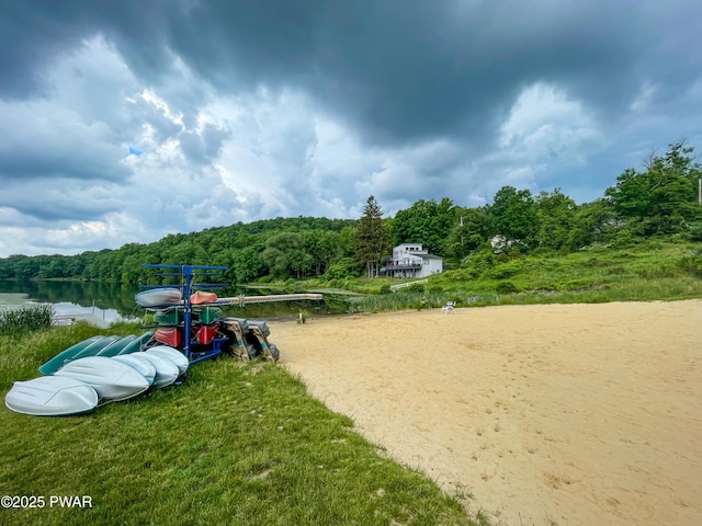 view of property's community with a forest view and a water view