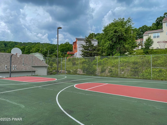 view of sport court featuring community basketball court and fence