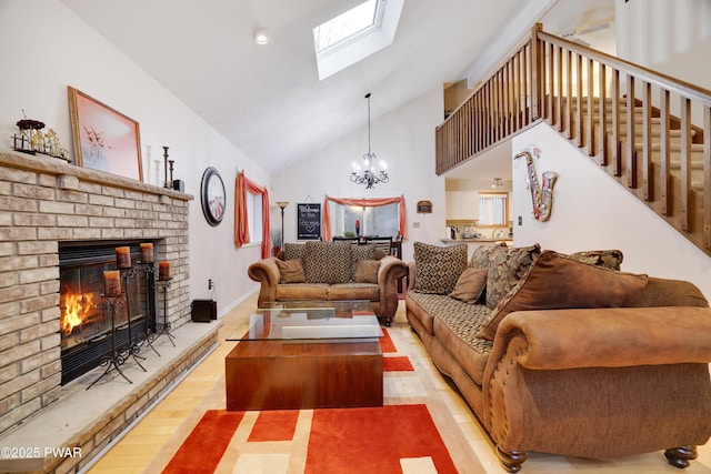 living area with wood finished floors, a skylight, a fireplace, stairs, and a chandelier