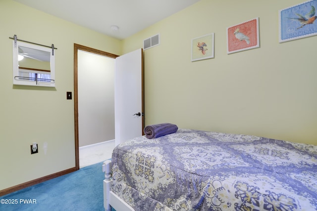 carpeted bedroom featuring baseboards and visible vents