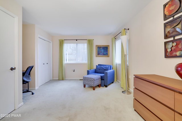 sitting room with baseboards and light colored carpet