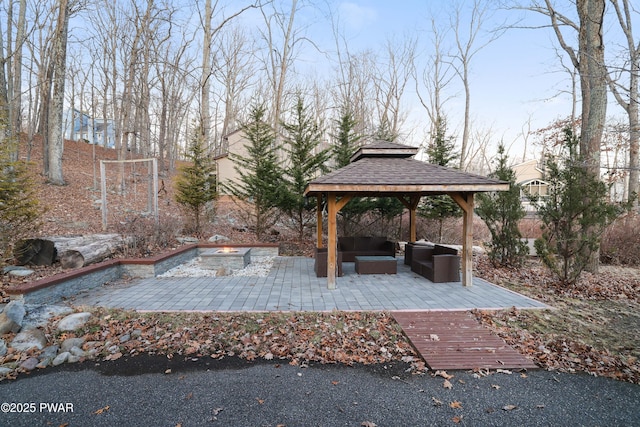 view of patio / terrace with a gazebo and an outdoor living space with a fire pit