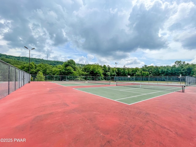 view of sport court featuring community basketball court and fence