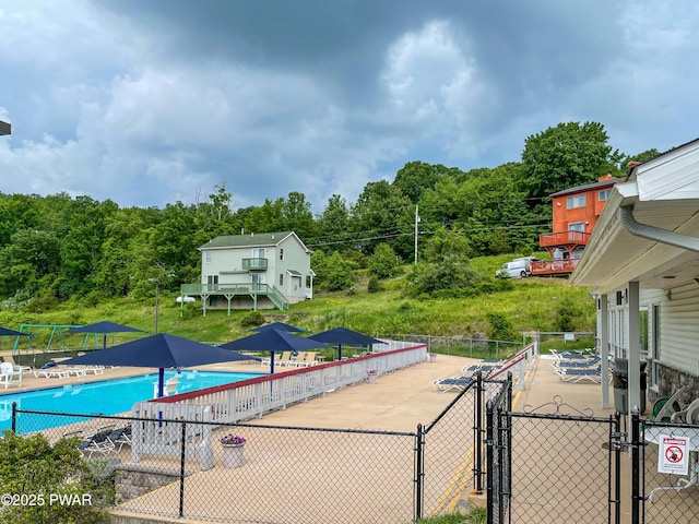 view of pool with fence and a gate