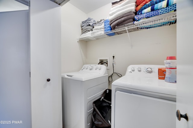 clothes washing area featuring washing machine and dryer and laundry area