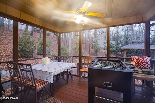 sunroom / solarium with wood ceiling and ceiling fan