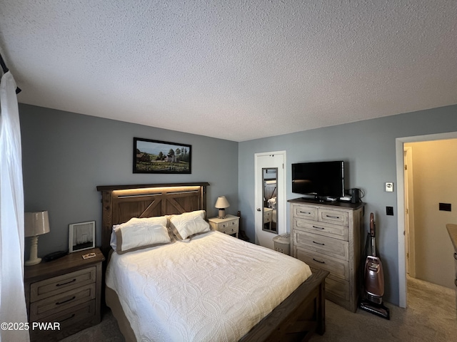 carpeted bedroom featuring a textured ceiling