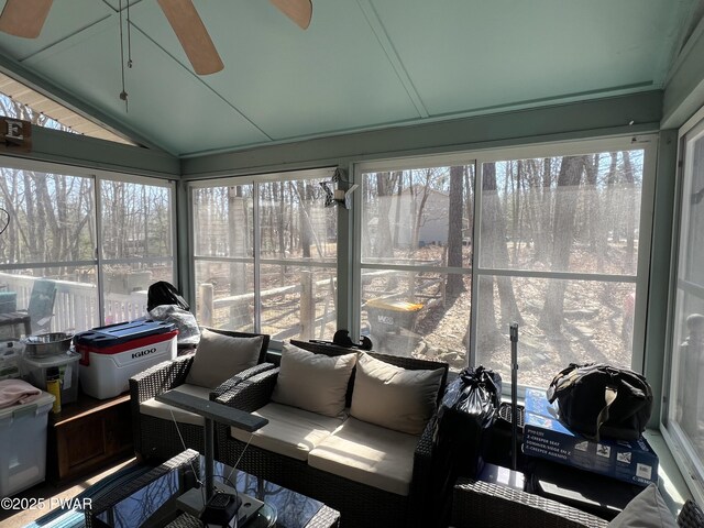 sunroom / solarium featuring a wealth of natural light, lofted ceiling, and ceiling fan