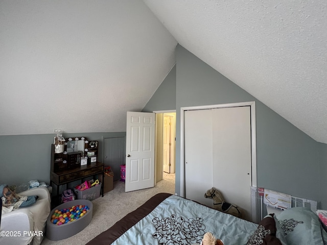 bedroom with a closet, a textured ceiling, carpet flooring, and vaulted ceiling